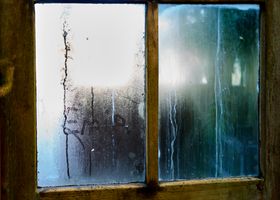 Blue hour through a misted window