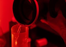 Hands mixing photographic chemistry